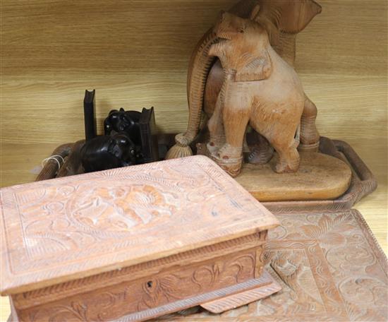 An Asian carved tray, a carved table top and carved elephants